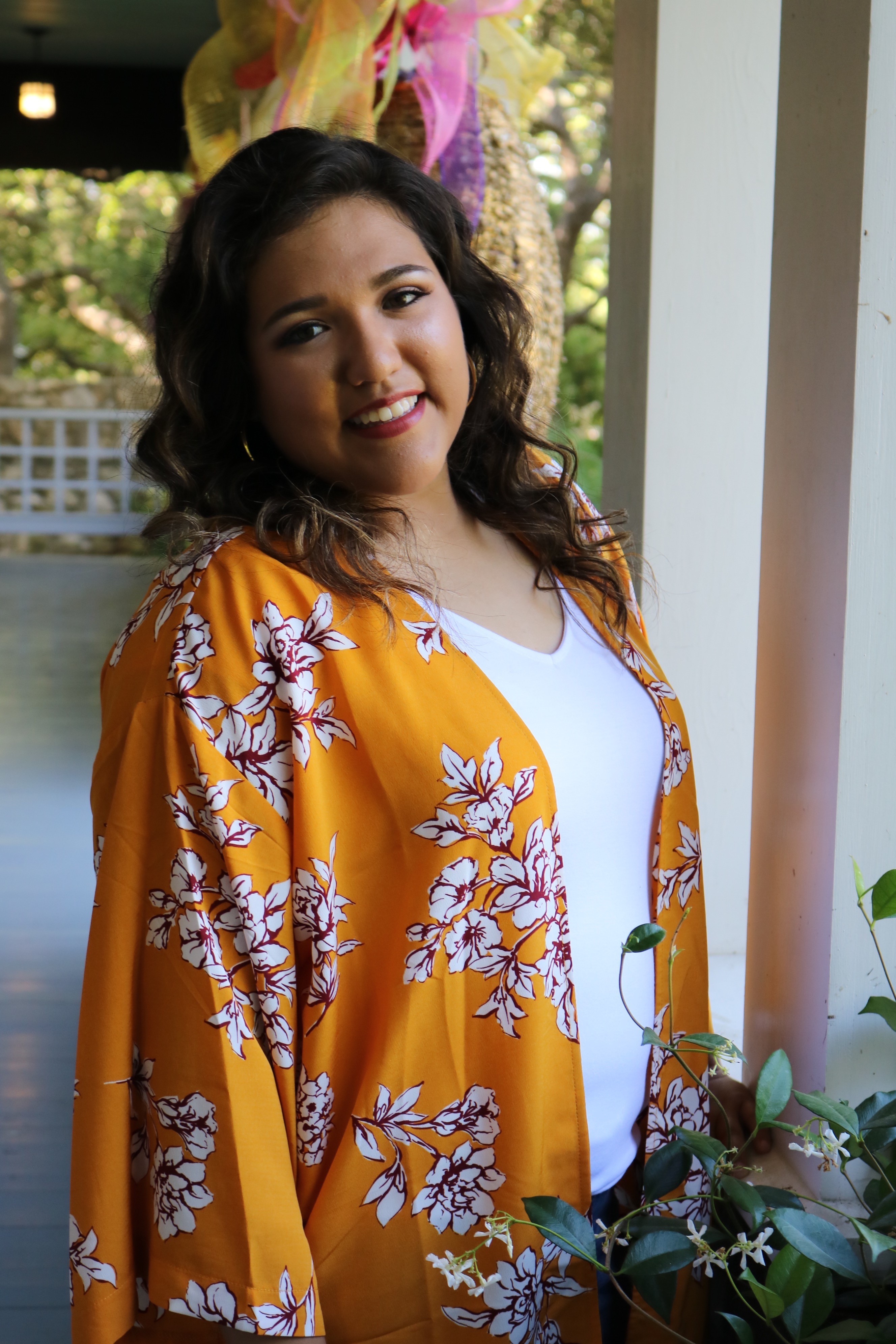 Image of Ava Borrego smiling and wearing a yellow top
